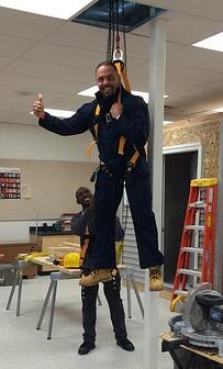 Dr. Durant gets a lift from TPS students when the Piping Industry visited Rogers High School.